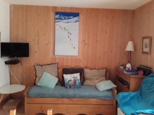 a living room with a couch with pillows on it at quereuilh in Le Mont-Dore