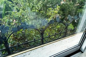a window with a bench looking out at trees at Hotel CITY Petrich in Petrich