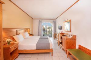 a hotel room with a bed and a window at Gillieru Harbour Hotel in St. Paul's Bay