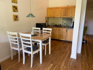 a kitchen with a wooden table and chairs in a kitchen at Apart Inn Feldstrasse in Winterberg