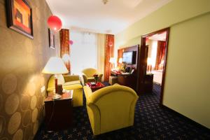 a hotel room with a couch and a chair at LEADER Al Muna Kareem Hotel in Medina