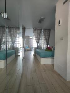 a living room with two beds and a wooden floor at BLU in Puerto del Carmen