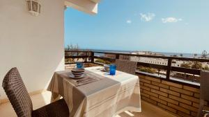 a dining table with a view of the ocean at Apartments Bambu in San Agustin