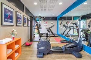 a gym with two treadmills and two ellipticals at Appart'City Confort Toulouse Purpan in Toulouse