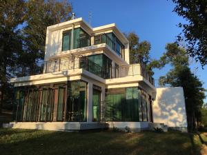 a large white house with a balcony at Greenville Maioli in Tongxiao