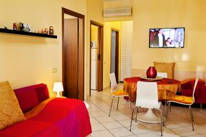 a living room with a couch and a dining room table at B&B Ai Cipressi in Lucca