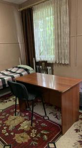 a room with a wooden desk and a bed at Hotel Uyut in Kremenchuk