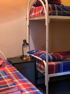 a bedroom with two bunk beds and a table with a lamp at Hotel Uyut in Kremenchuk