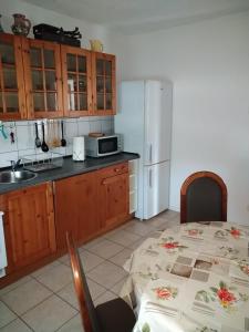 a kitchen with a table and a white refrigerator at Dori's Fewo in Mittenwalde