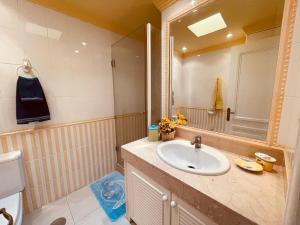 a bathroom with a sink and a mirror at Apartments Bambu in San Agustin +41 photos