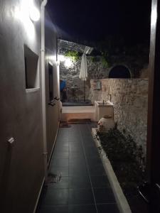 a dark hallway with a sink and a table at night at KOTRONAS FLOWER in Kótronas