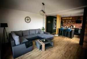 a living room with a couch and a table at Apartman PAOLA in Slavonski Brod