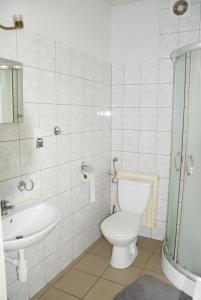 a bathroom with a toilet and a sink at Apartament Adabet in Kępno