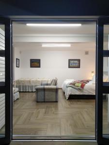a living room with two beds and a sliding glass door at Somerset View Guest House in Somerset West +93 photos