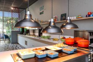 a kitchen with several dishes of food on a counter at Holiday Inn Bournemouth, an IHG Hotel in Bournemouth