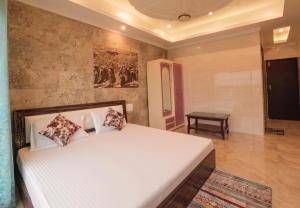 a bedroom with a large white bed in a room at Hotel Grand Galaxy in Rishīkesh