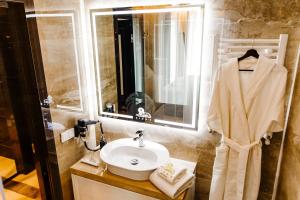 a bathroom with a sink and a mirror at Lion's Hotel in Chişinău