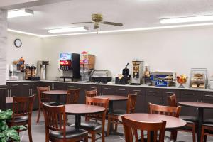 a restaurant with tables and chairs and a counter at Super 8 by Wyndham Chillicothe in Chillicothe