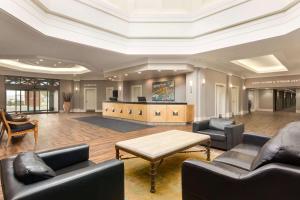 a living room with couches and a coffee table at Royal Hotel Calgary, Trademark Collection by Wyndham in Calgary