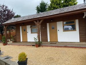a small house with wooden doors in a yard at Beechwood in Bristol