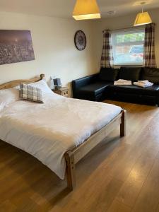 a bedroom with a large bed and a couch at Beechwood in Bristol