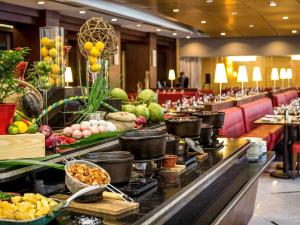 a buffet line in a hotel with food on it at Novotel Sao Paulo Jaragua Conventions in Sao Paulo