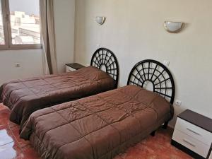 a bedroom with two beds and a window at Cotillo Faro in Cotillo +15 photos