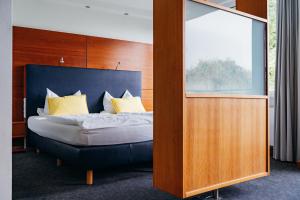 a bedroom with a bed and a large window at Hotel Benther Berg in Ronnenberg +43 photos