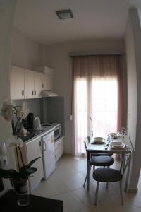 a kitchen with a table and a table and chairs at Mare D'Oro in Sarti
