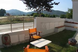 a patio with a table and two chairs on a balcony at Mare D'Oro in Sarti