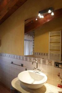 a bathroom with a white sink and a mirror at Casa Rural Ca Lazaro in Bot