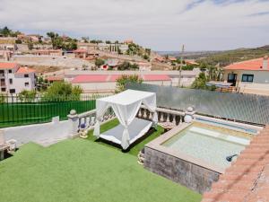 a patio with a table and a swimming pool at Casa rural las Eras in Valdelaguna