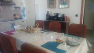 a table with plates and dishes on it in a kitchen at Casa Giulia in Porto SantʼElpidio