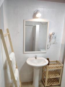 a bathroom with a sink and a mirror at Aconchego do Pilar in Ouro Preto