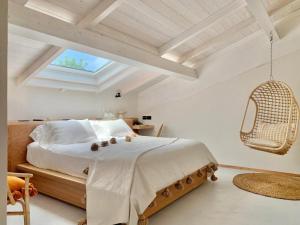 a bedroom with a large bed and a skylight at Santa Lucia Maccarese - Residenza Agricola in Maccarese
