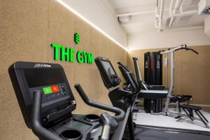 a gym with a treadmill and exercise equipment in a room at Botanique Hotel Prague in Prague