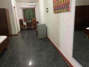 a hallway with a room with a refrigerator in it at Tills Beach Resort in Fetta