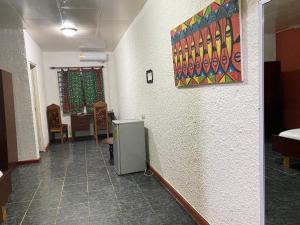 a hallway of a room with a painting on the wall at Tills Beach Resort in Fetta