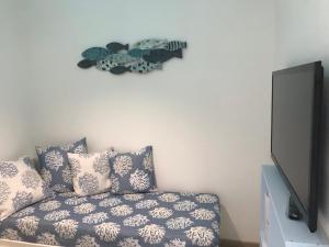 a living room with a couch and a flat screen tv at my happy place in Lido di Camaiore