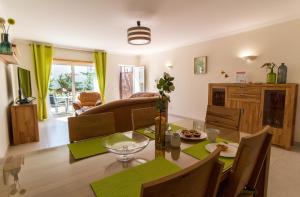 a dining room and living room with a table and chairs at Cliff-Top Townhouse with Stunning Ocean Views in Carvoeiro