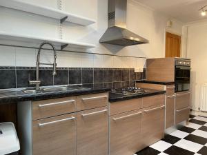 a kitchen with a sink and a stove at Tivoli Bungalow in Weston-super-Mare