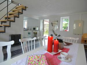 a kitchen and dining room with a table and a staircase at Ferienhaus Christine in Schenkendöbern