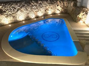 a swimming pool with blue water in a building at Colina del Sol Cullera - Villa Sol in Cullera