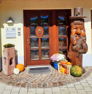 a front door of a house with a statue at Gästehaus Haaser in Bad Peterstal-Griesbach