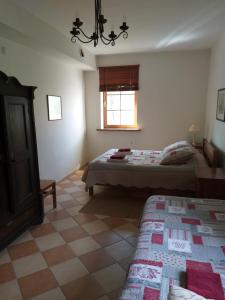 a bedroom with two beds and a window at Brīvdienu māja Dukāti in Cesvaine