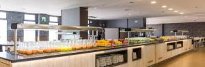 a buffet line with a bunch of fruits and drinks at Ilunion Calas de Conil in Conil de la Frontera