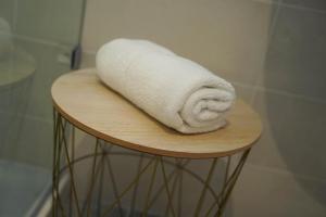 a white towel sitting on top of a wooden table at Guest House Capital Inn in Valletta