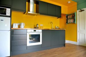 
A kitchen or kitchenette at Beechurst Serviced Apartments
