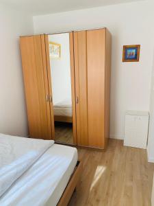 a bedroom with a mirror and a bed at Ferienwohnung im Spessart / Aschaffenburg in Johannesberg