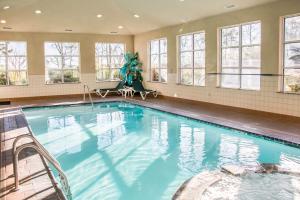 a large swimming pool in a building with windows at Sleep Inn & Suites Ruston Near University in Ruston